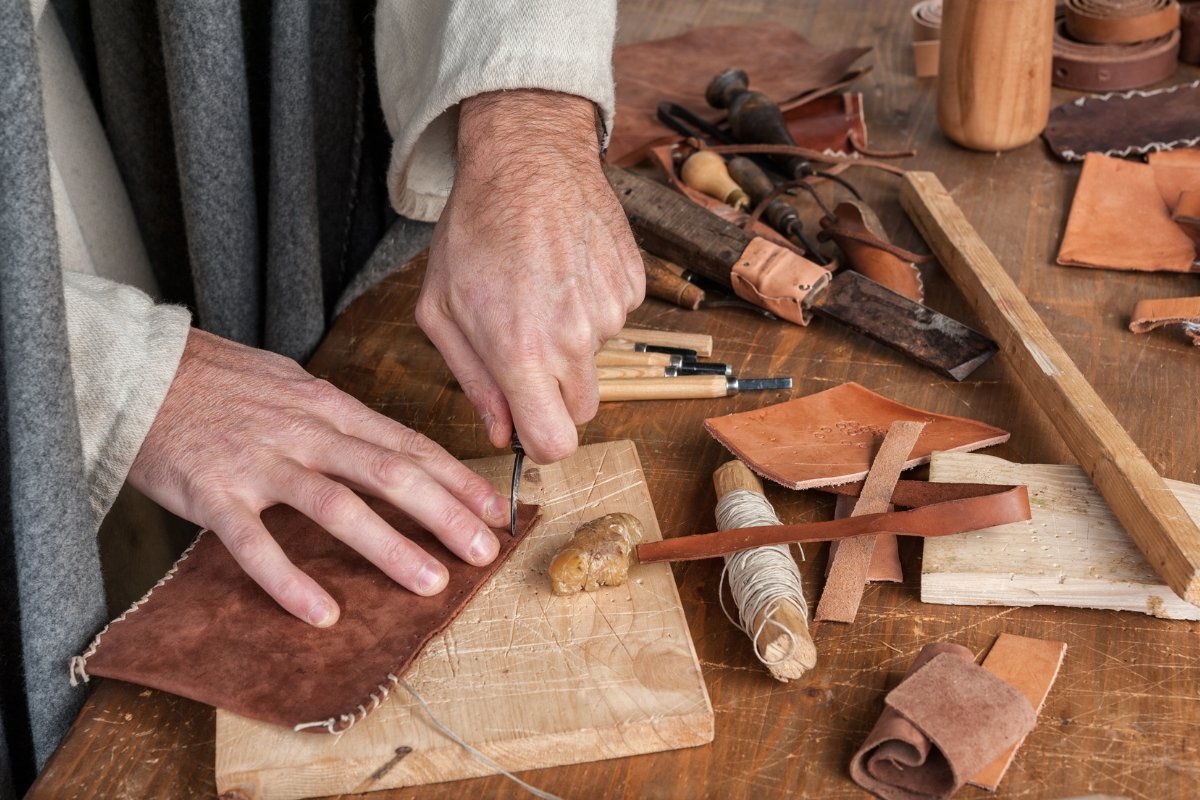 A man working on a leather piece