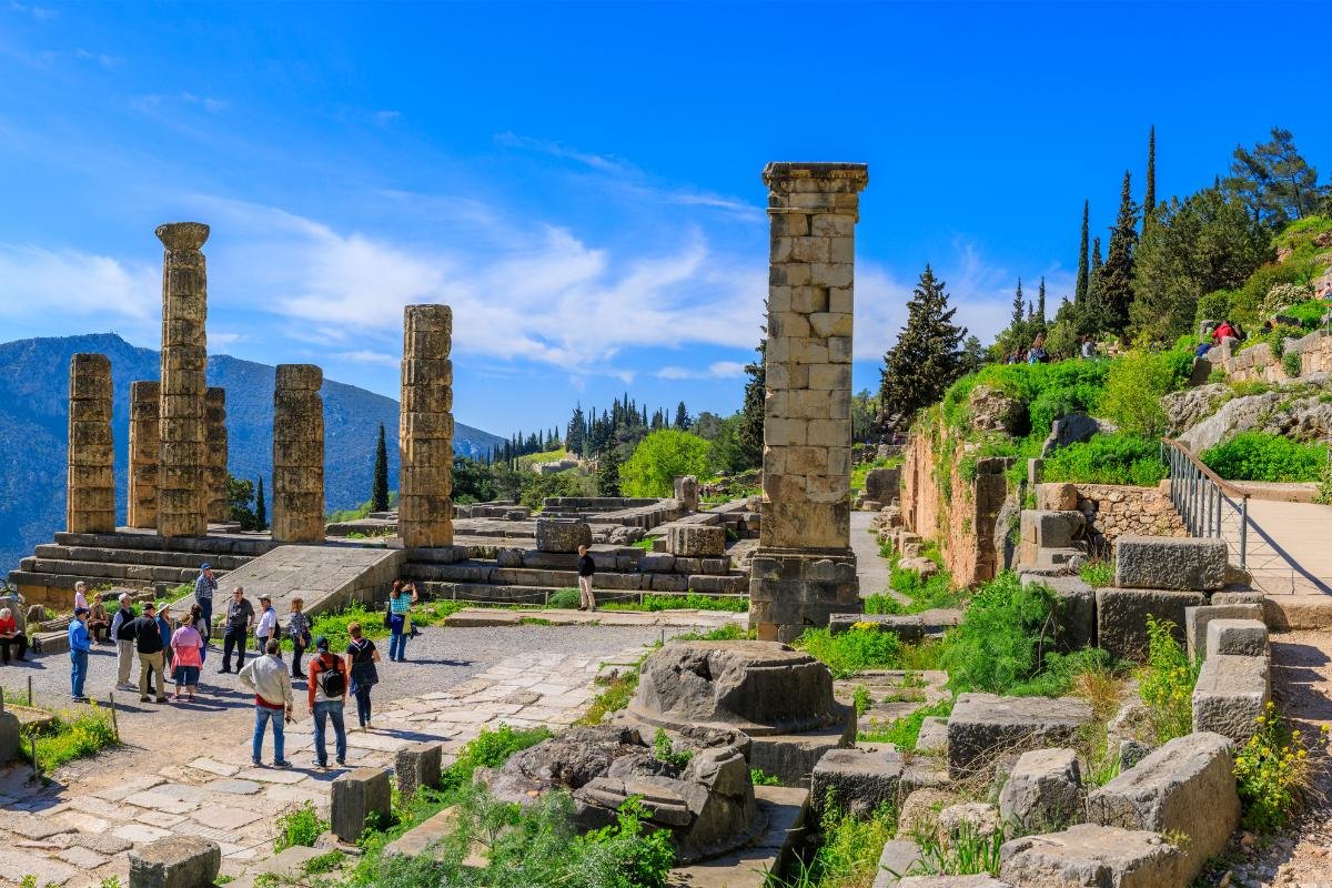 Stone ruins of Delphi temple surrounded by green hills near Arachova
