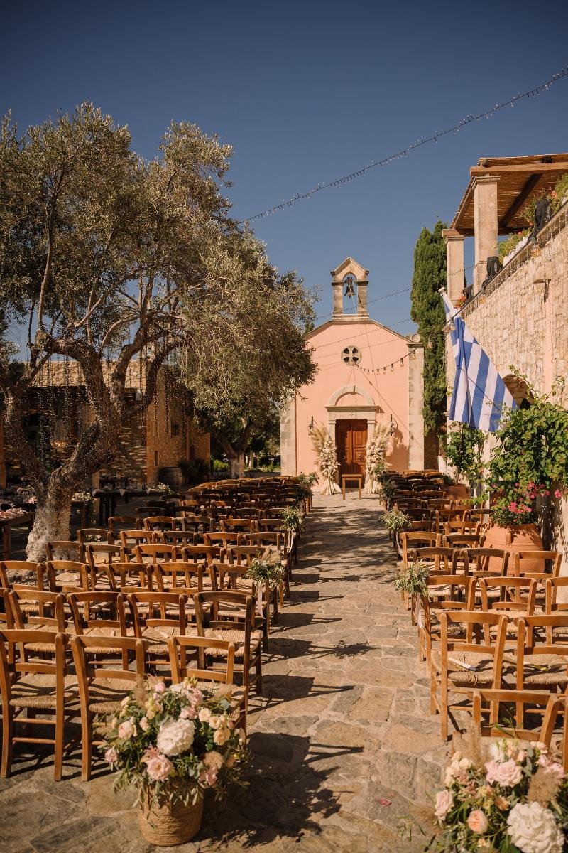Stone path leading to a charming chapel in Crete, set for a Greek wedding ceremony