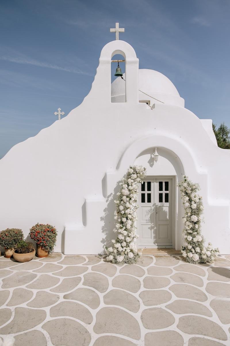 Classic white chapel in Mykonos prepared for a romantic destination wedding