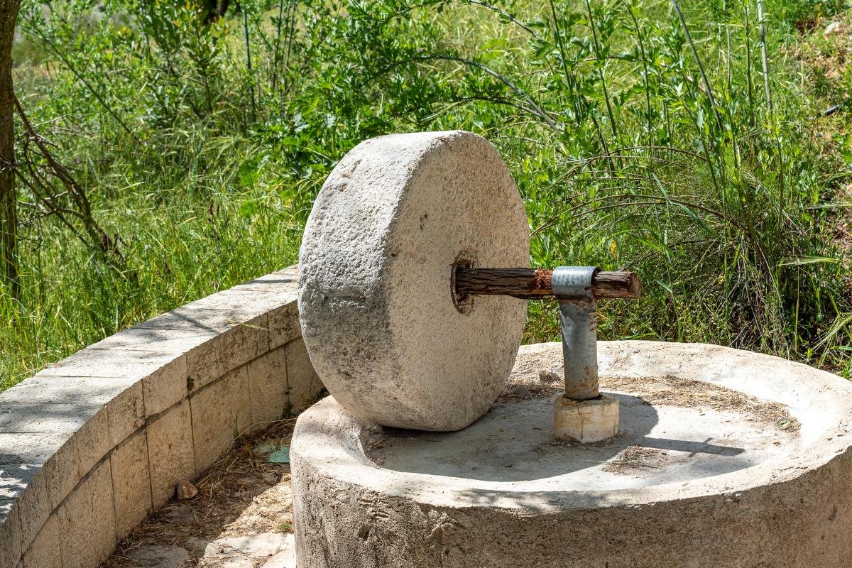 Historic stone olive press used in traditional Greek olive oil production