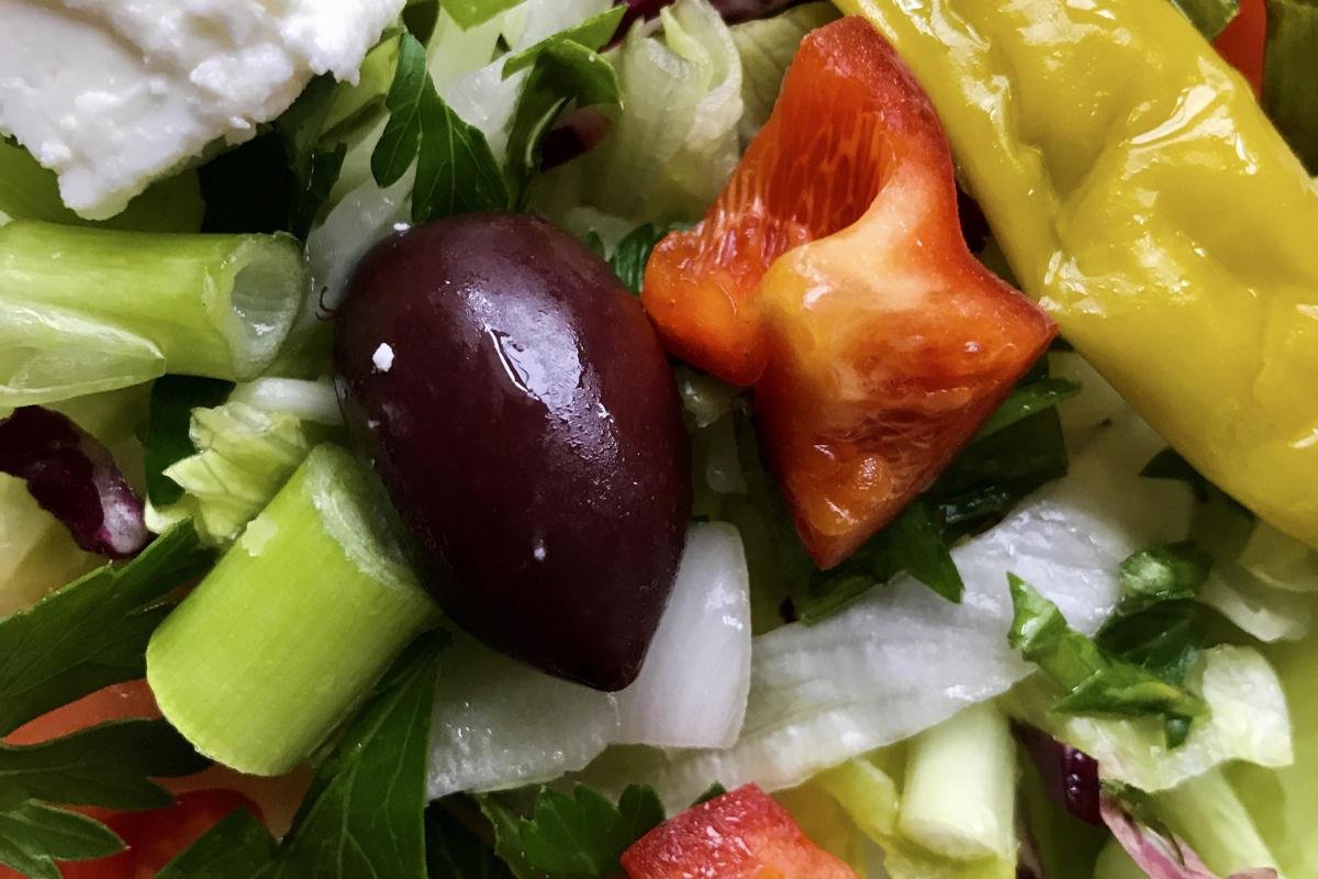 Close-up of traditional Greek salad with olives, feta, and olive oil