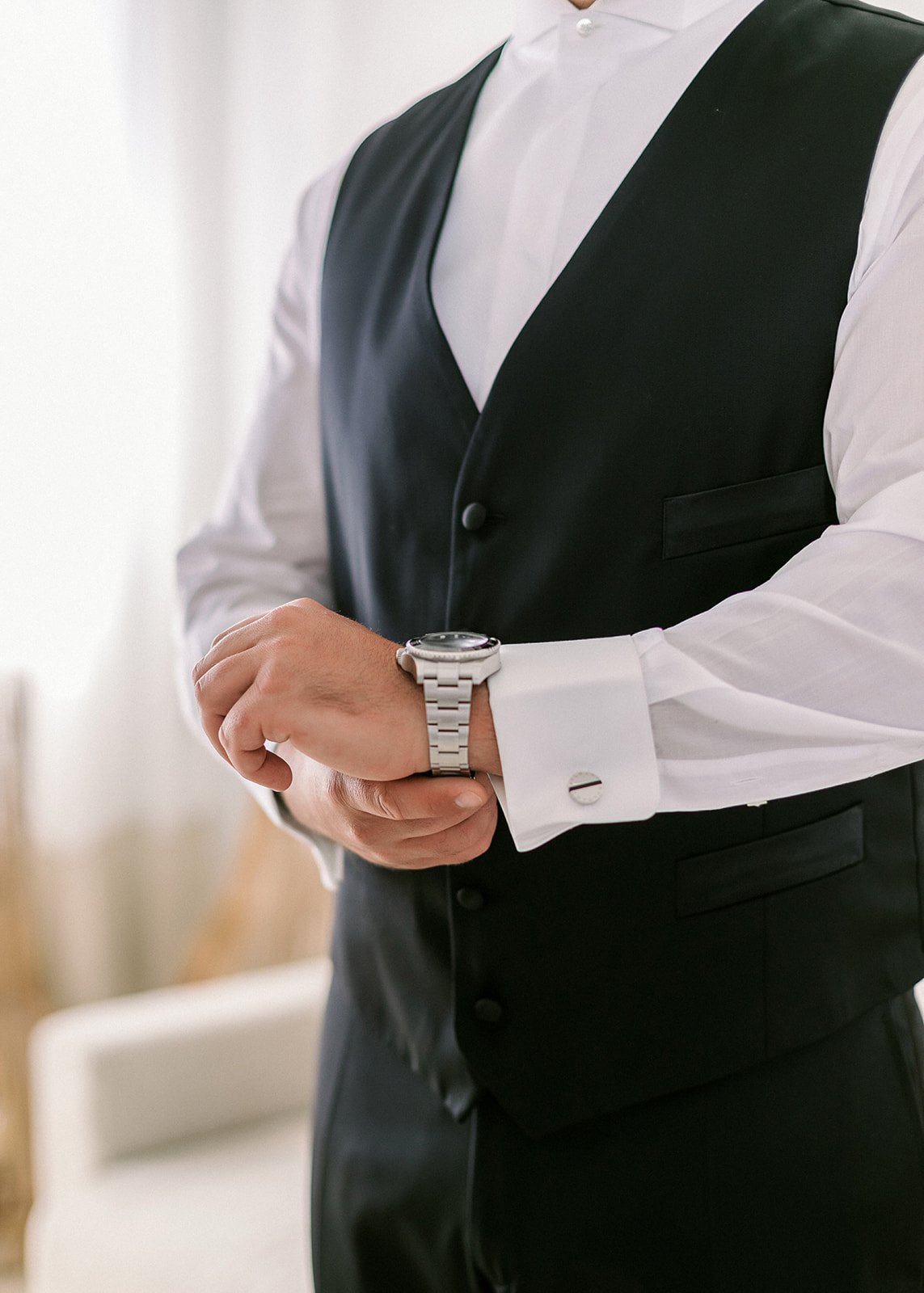 A groom is getting ready during a greek wedding in Santorini