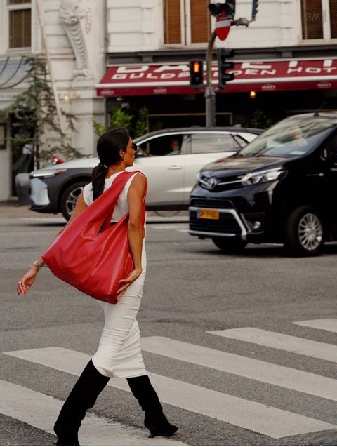 A stylish woman walking the road in a mediterranean inspired dress