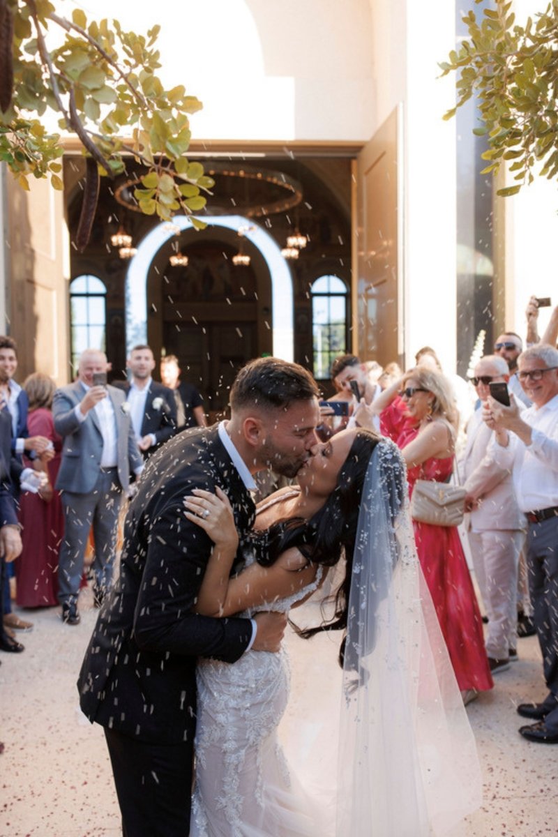 Bride and groom showered with rice after their church wedding ceremony in Greece
