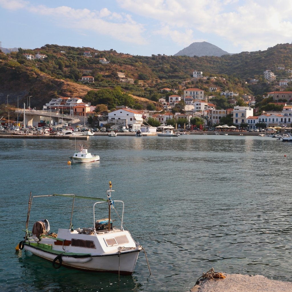 A small fishing boat docked at the harbor of an Ikarian village, showing the island’s calm and traditional pace of life.